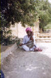 Mad singing Rajput man accosting us at Jaisalmer lake. We had to pay him 5 rupees to go away!